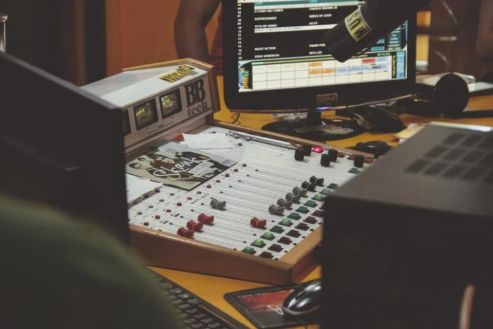 Radio mixing console and monitor in a working studio
